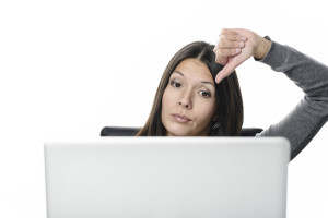 Unsatisfied Woman with Laptop Showing Thumbs Down